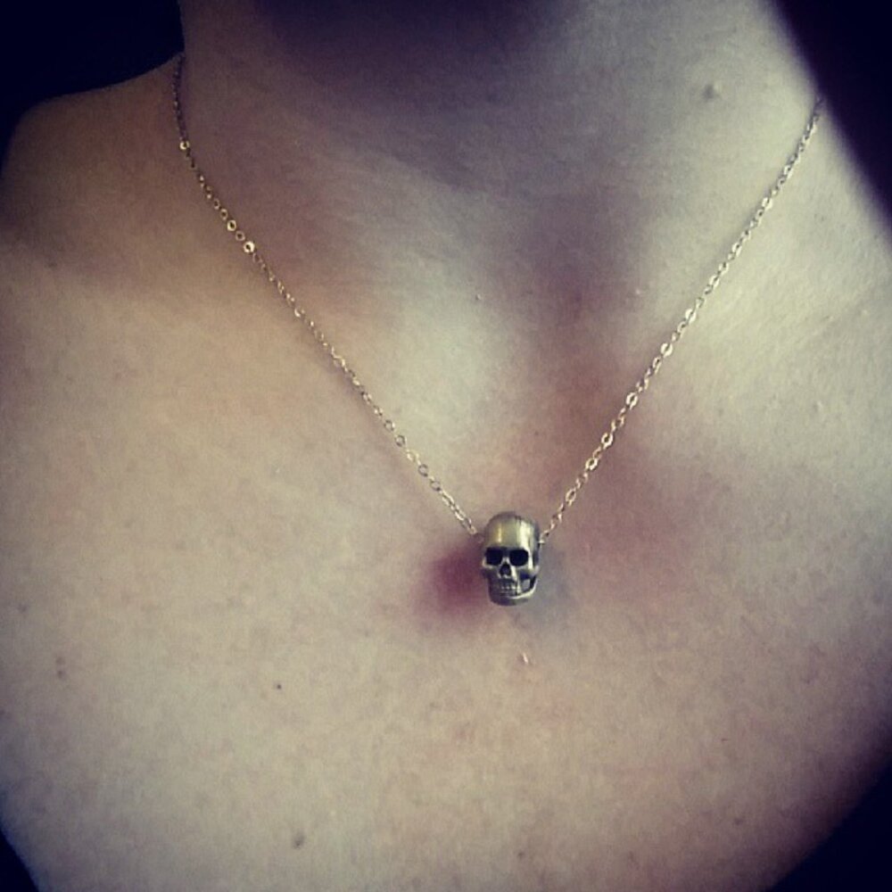 Gold hand carved skull necklace.